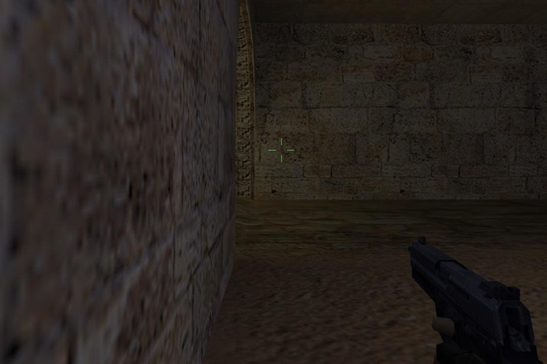 Close-up view of a green crosshair in Counter-Strike 1.6 at 1920x1080 resolution, showing a pistol aimed down a stone hallway