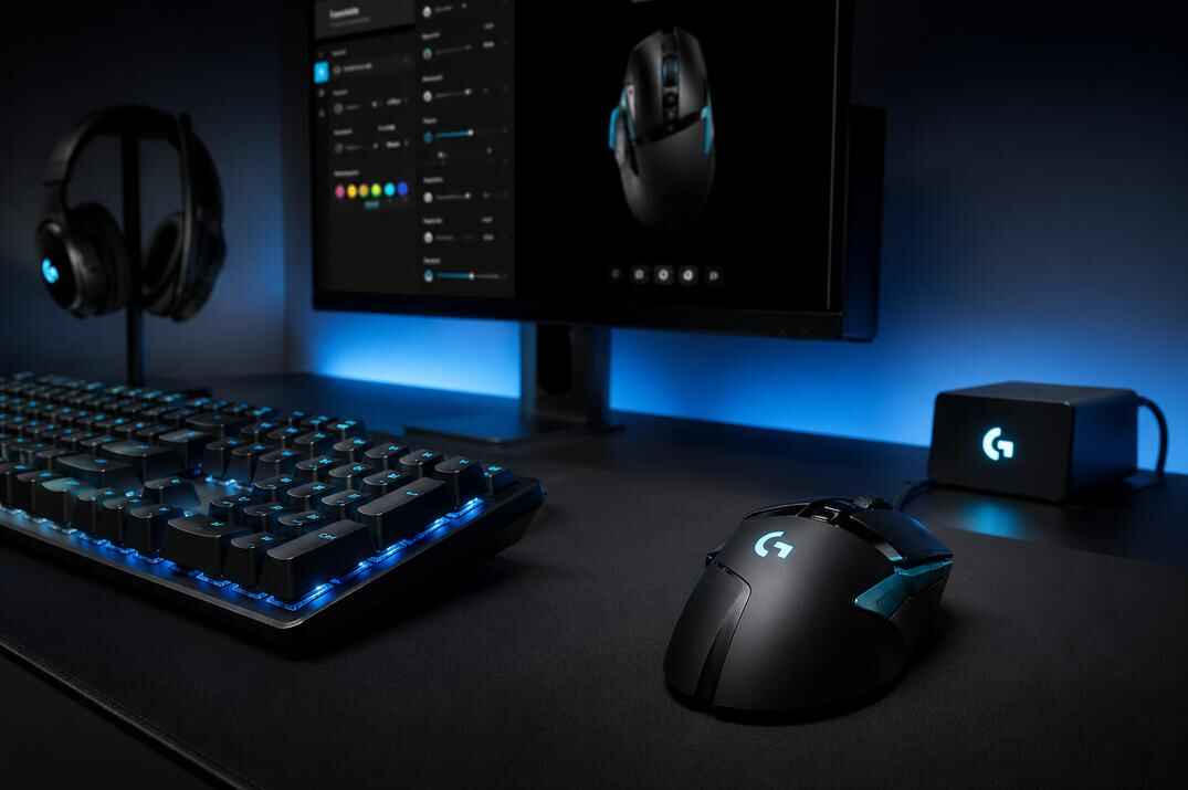 Logitech G gaming mouse and keyboard on a dark RGB desk setup with G HUB-style software shown on the monitor