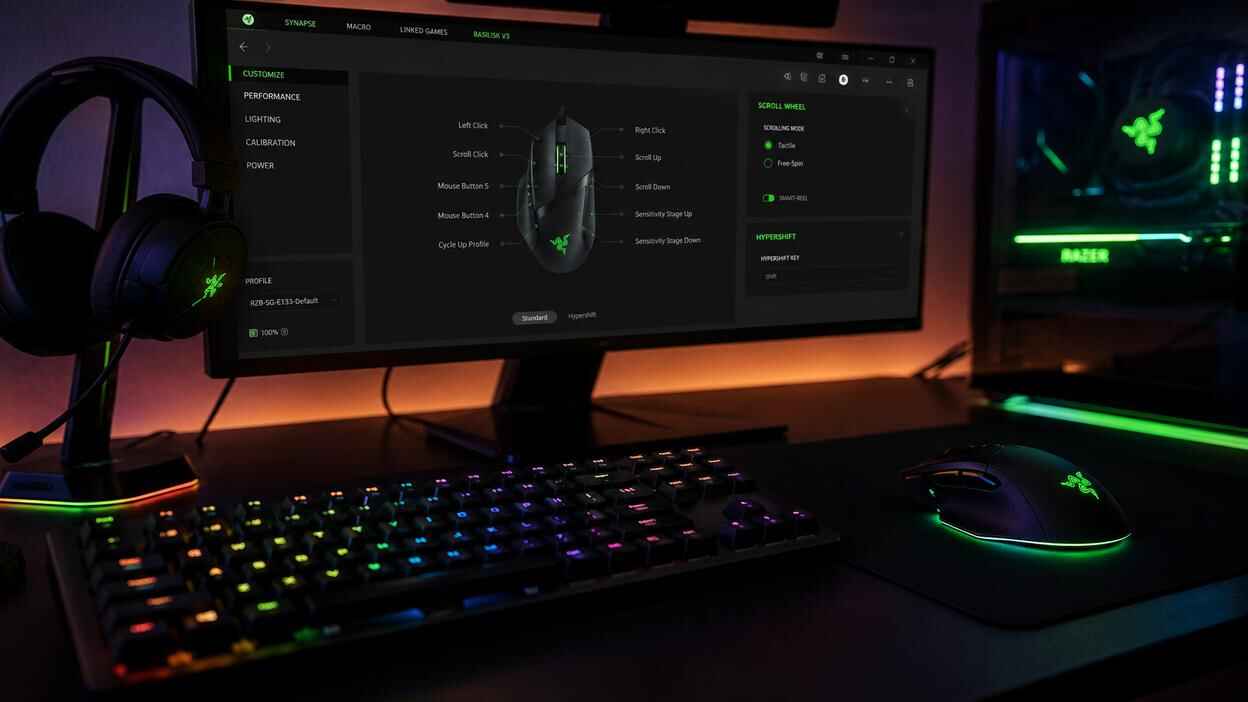 Razer Synapse 4 interface on a gaming monitor with RGB Razer mouse, keyboard, headset, and PC setup